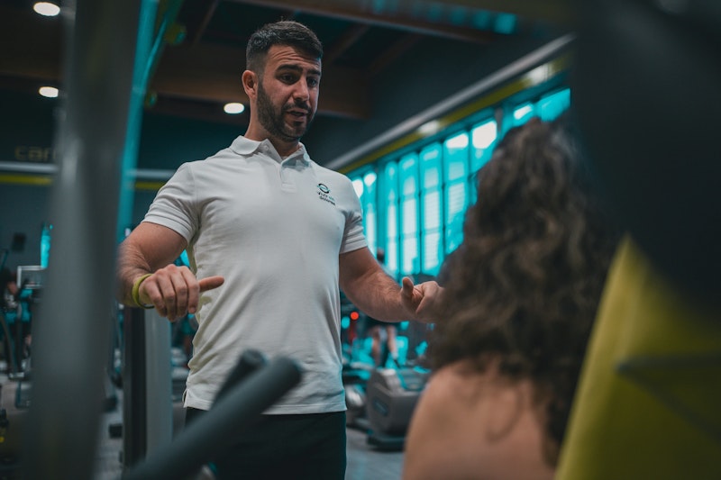 A man at the gym looking focused during a personal training session – challenging common myths and highlighting the real benefits of personal training.