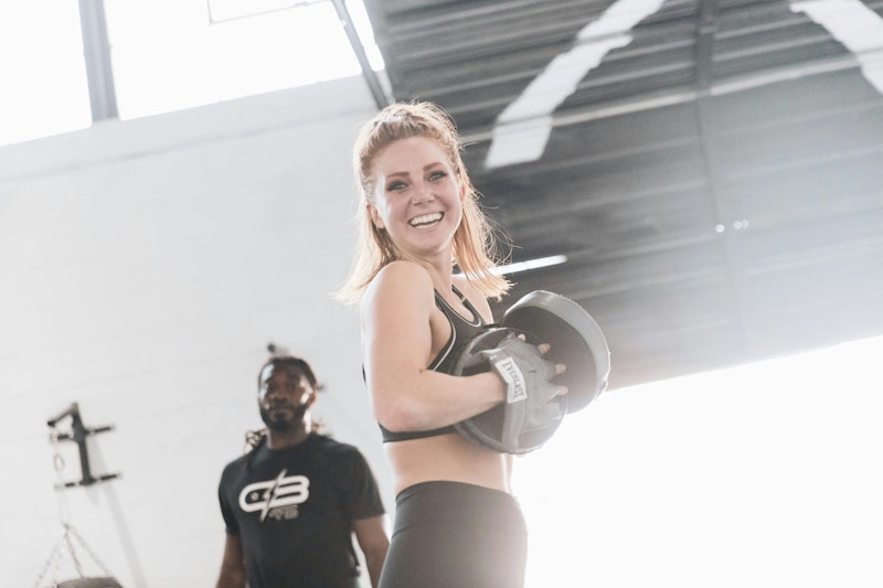 A smiling woman after a personal training session – capturing the top personal training benefits like confidence, motivation, and improved fitness.