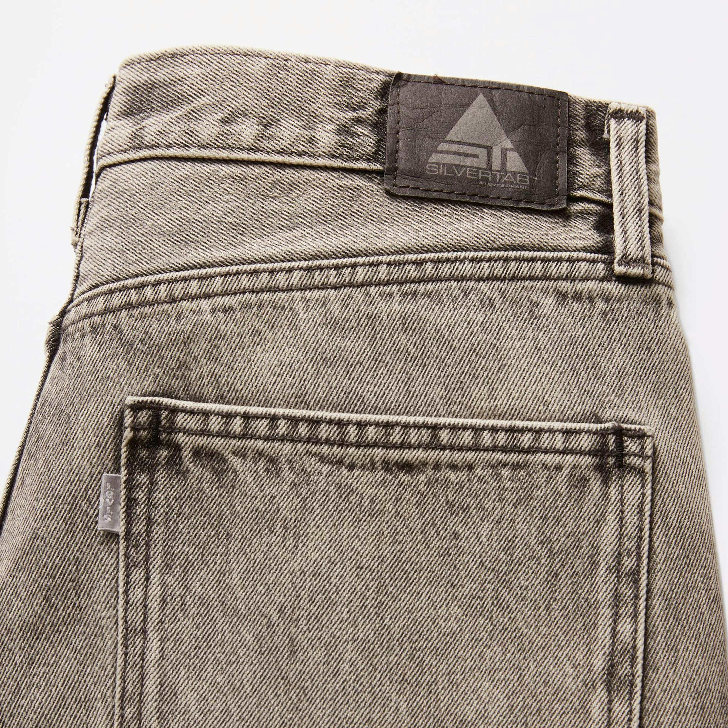 The hip pocket tab that turned into silver as a signature, and no Arcuate Stitching