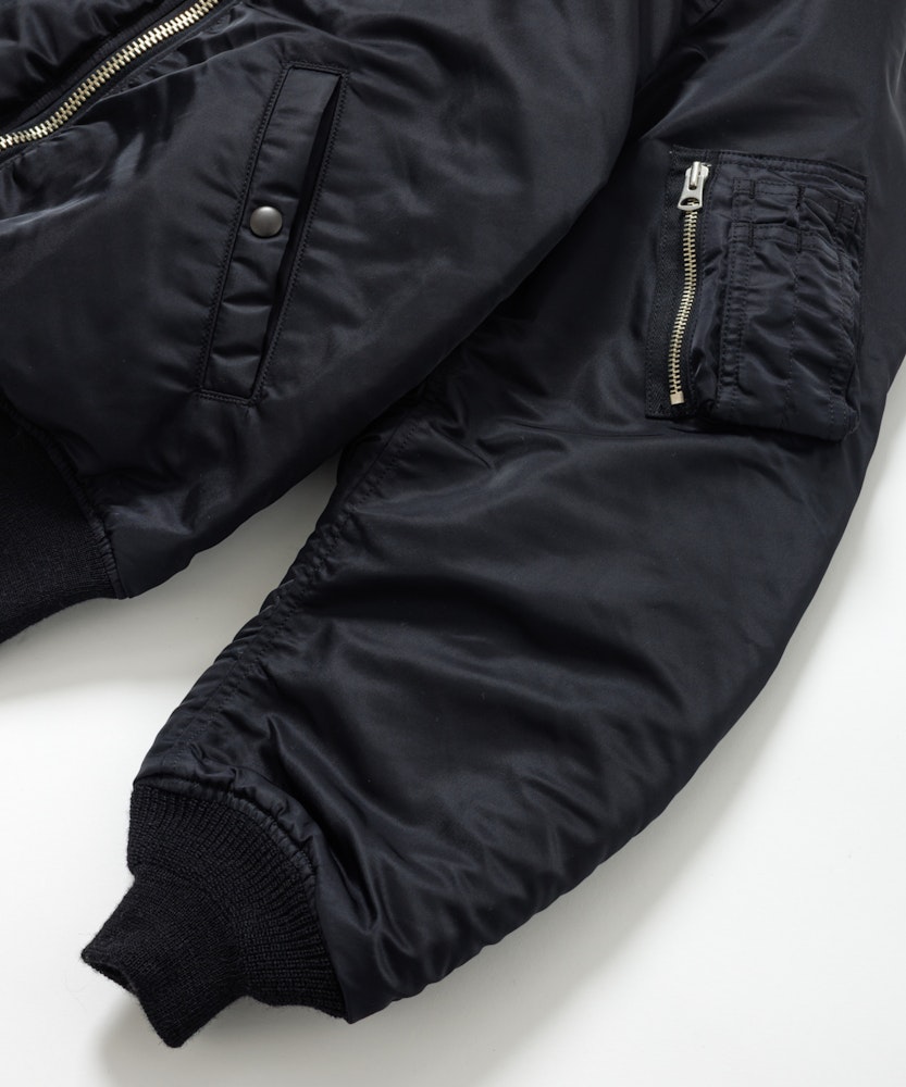 <p>生地には耐久性のある66ナイロン、中綿にはリサイクル素材とウールモッサ端材を採用。袖リブは希少織機によるウール100%チューブリブで、快適な着用感と環境への配慮を両立。</p>