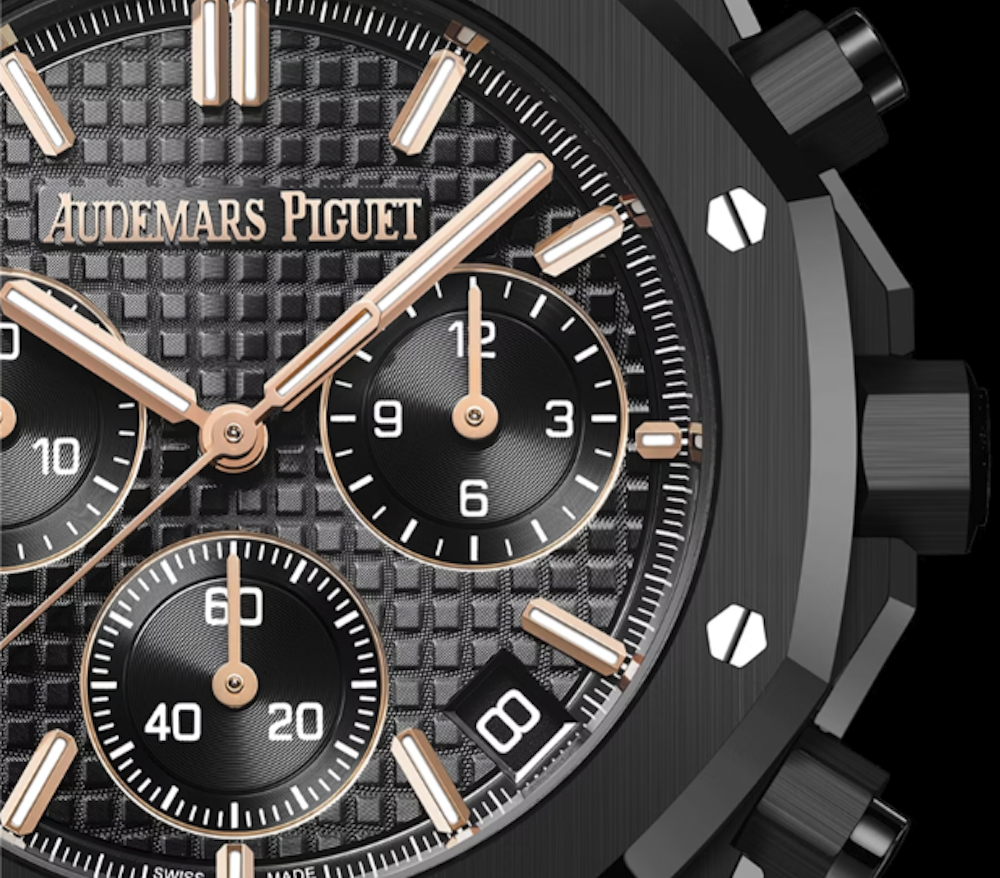 <p>ブラックの「グランデ・タペストリー」パターン文字盤に、ピンクゴールドのアップライドインデックスとロイヤルオーク針（夜光付き）を備え、視認性と質感を両立。</p>