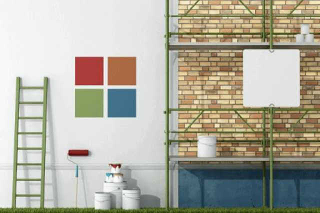 はしごや塗料、ローラーやハケが写っている外壁塗装をイメージした画像