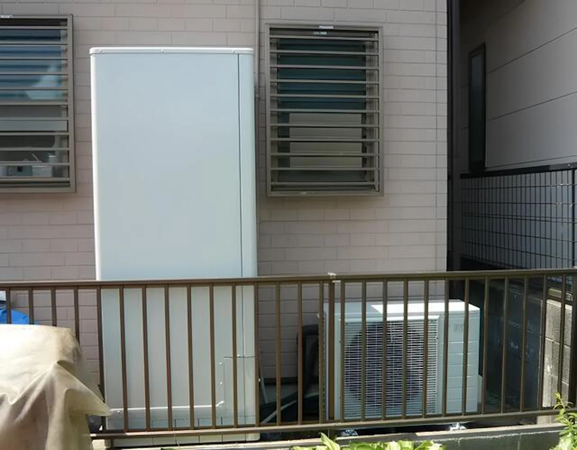 ピンク壁の一戸建て住宅に設置しているエコキュート
