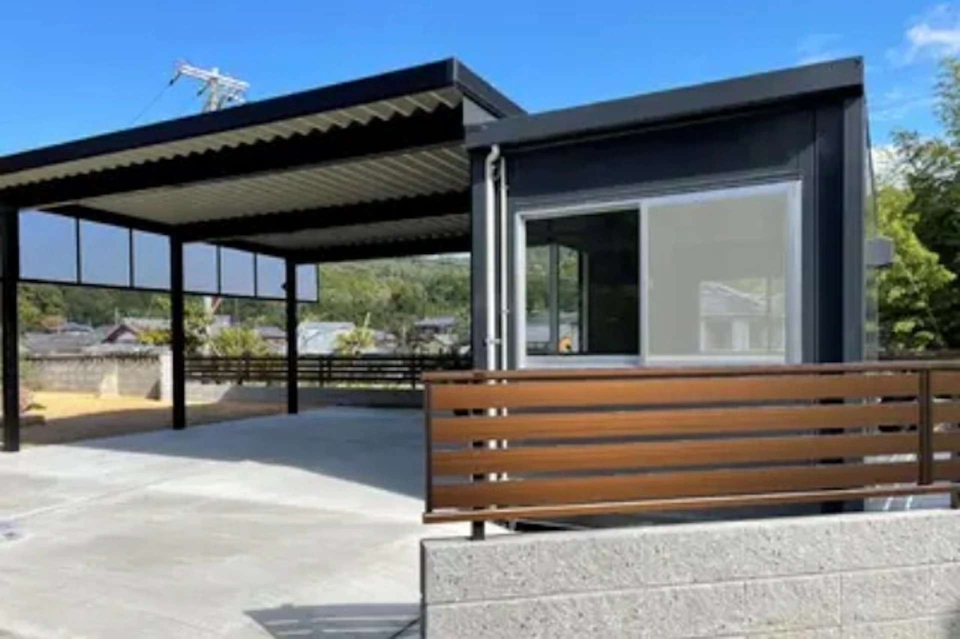 黒と白を基調に物置とガレージを配置した事例