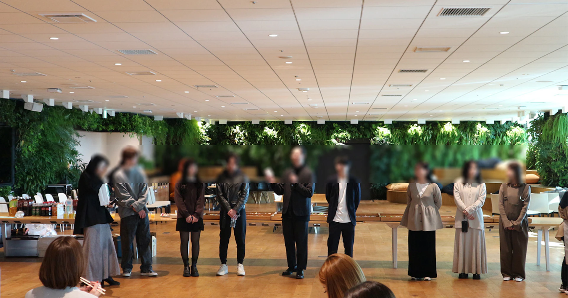 横一列に並んだ9人の男女の写真