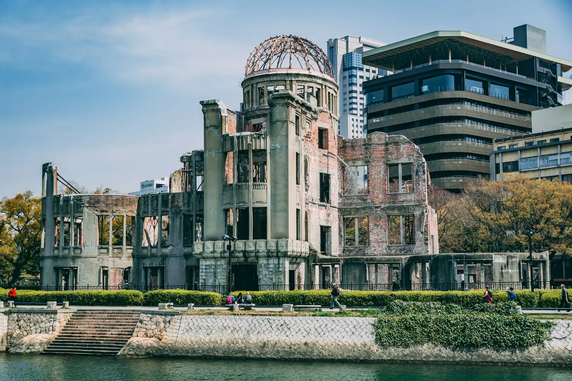 Historic Hiroshima atomic bomb Dome standing amid modern city buildings