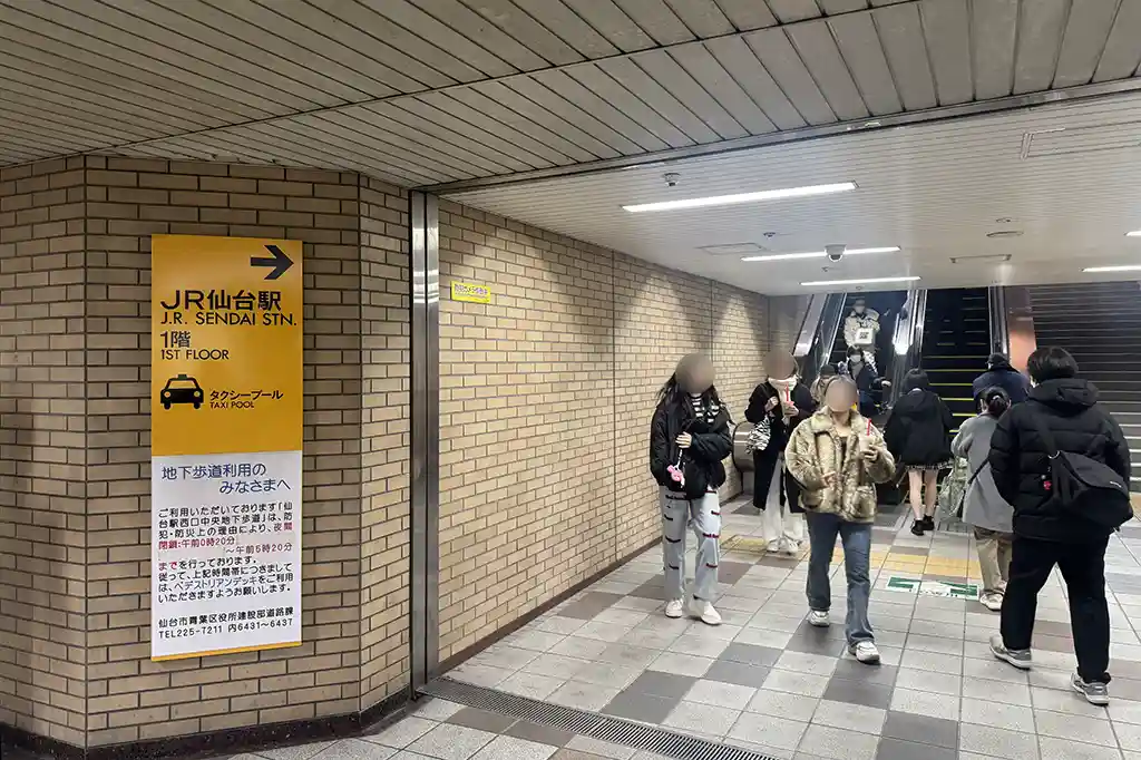 Escalator at Sendai Station leading from the underground walkway up to street level near station exits.
