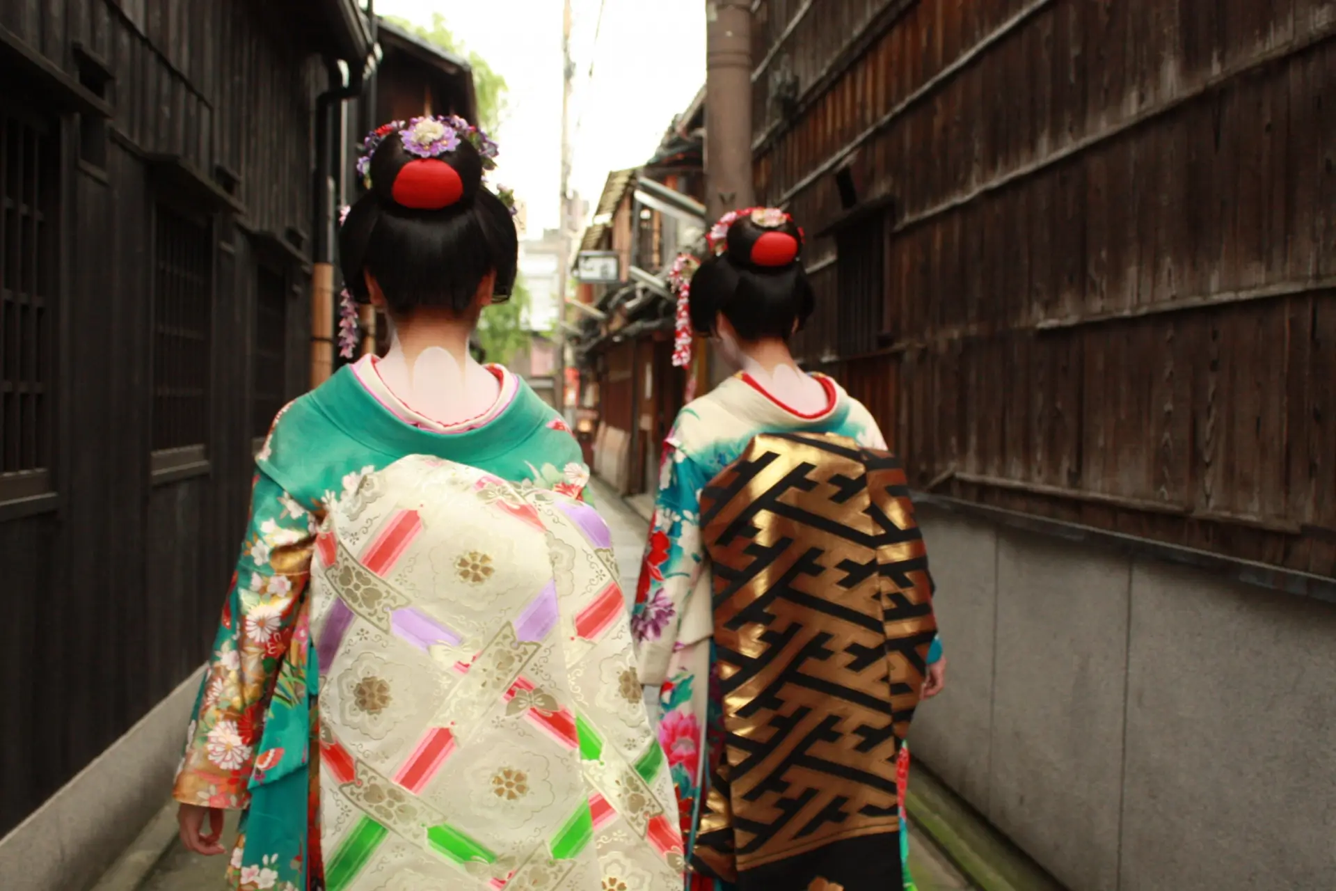 Two women dressed as geisha walking through Kyoto’s historic Gion district