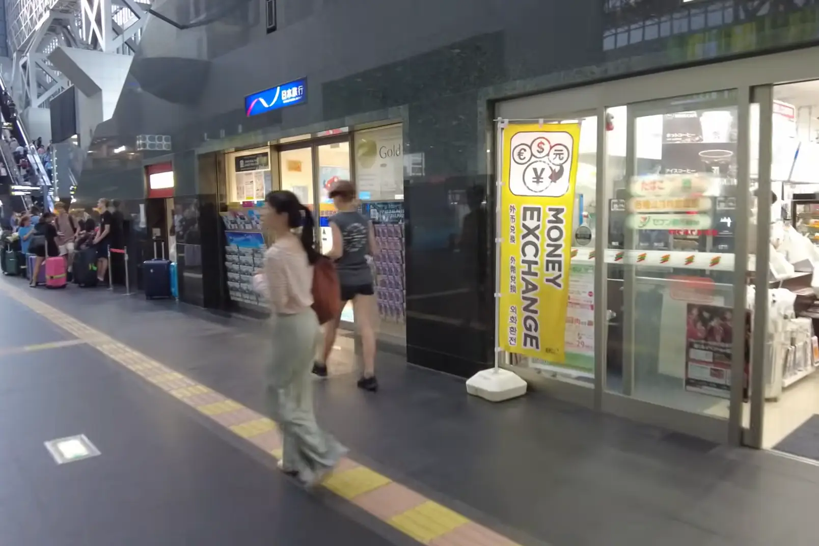 Money exchange service for international travelers at Kyoto Station with multilingual signage