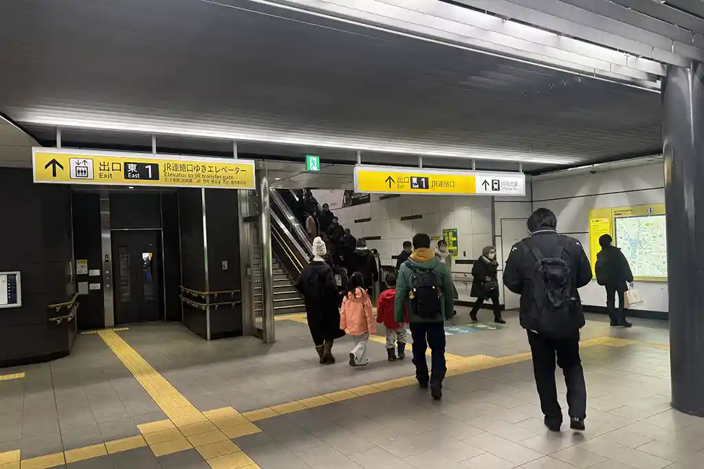 Sendai Subway Station area with an elevator and escalator near the ticket gates for moving between exits and platforms.