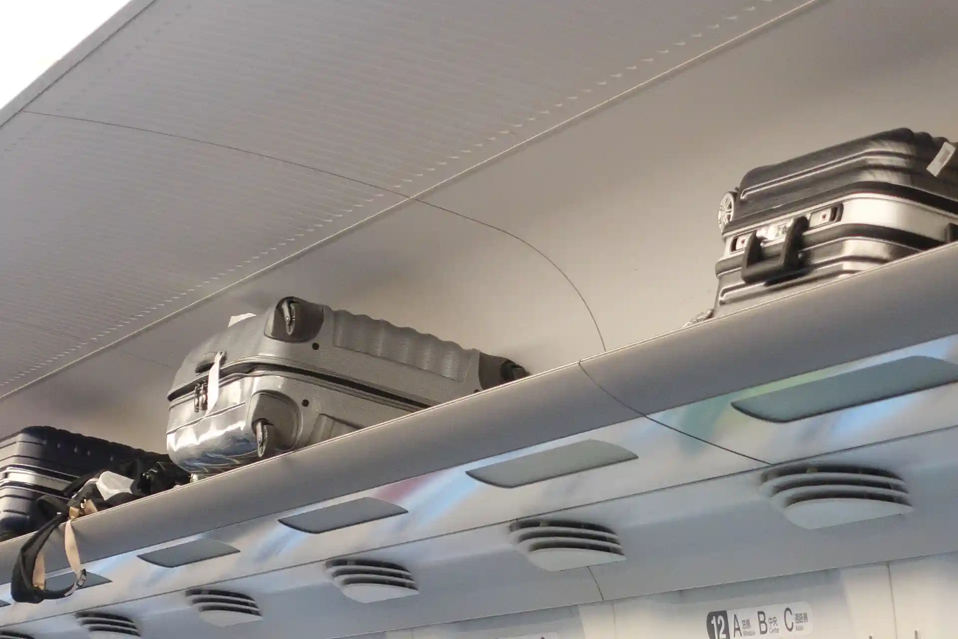 Luggage rack inside the Hokkaido Shinkansen, used for storing carry-on suitcases above the seating area