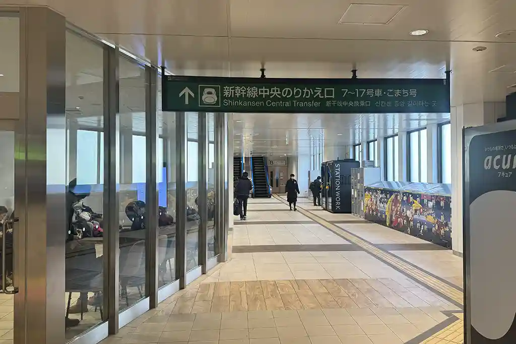 Escalator inside Sendai Station guiding passengers from the local line area on the second floor up to the Shinkansen level.