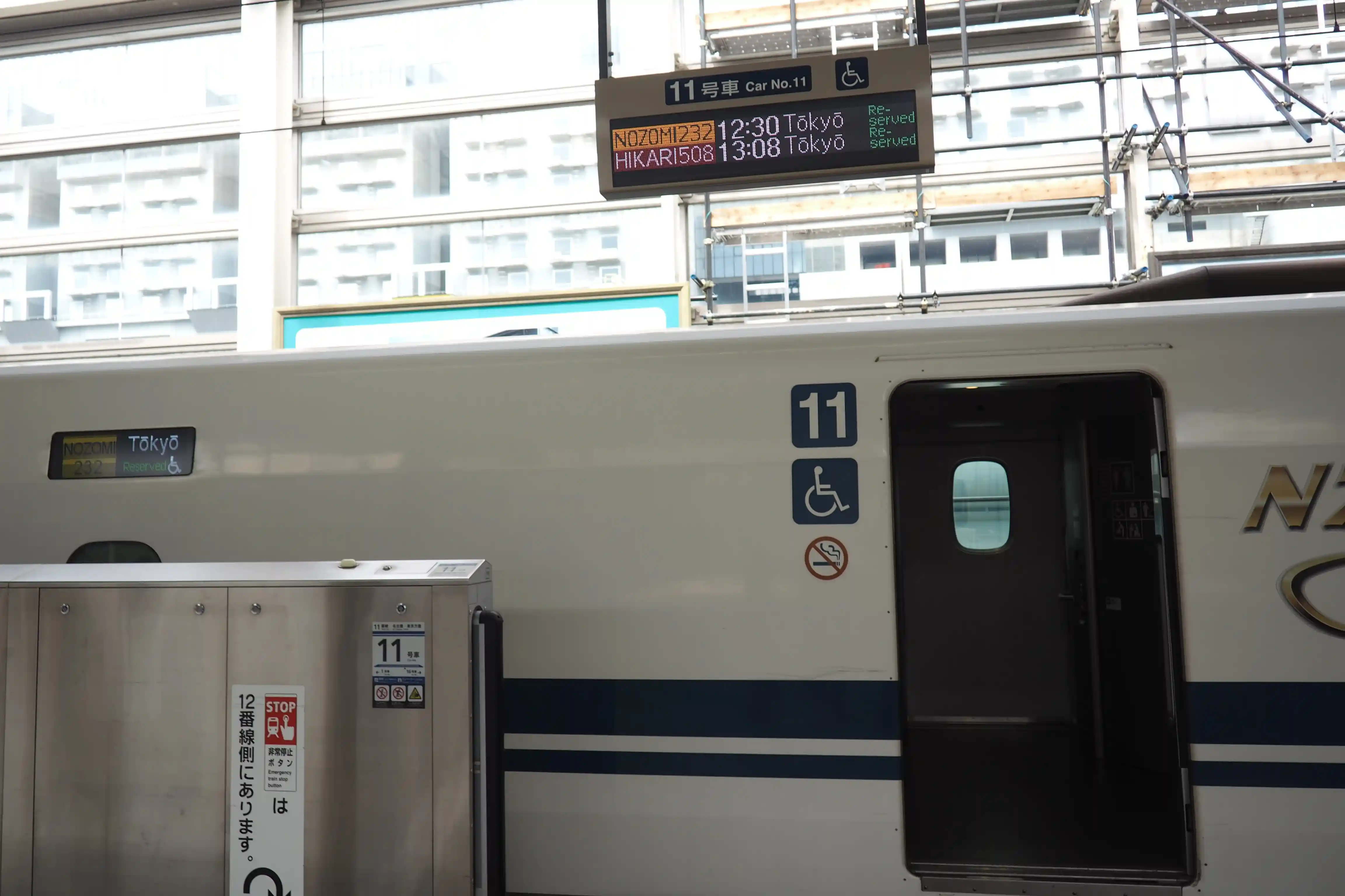 Reserved car of the Shinkansen at Kyoto Station with platform indicators and boarding doorway visible