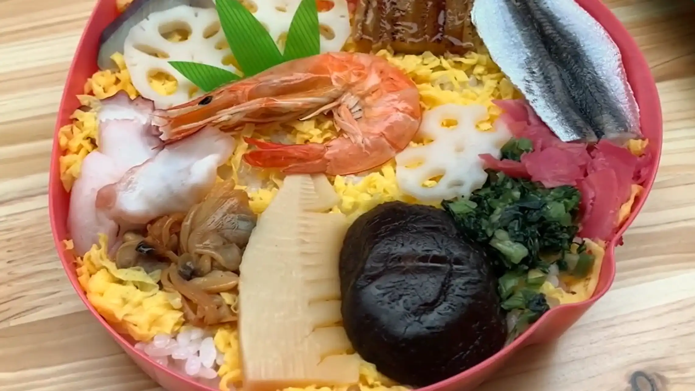 Momotaro Matsuri Zushi in a peach-shaped bento box, a famous ekiben from Okayama Station