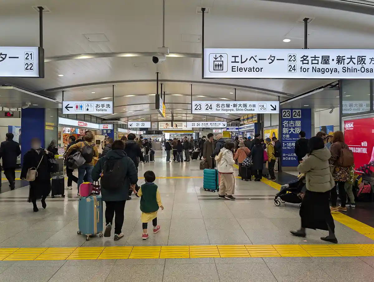 Inside Shinkansen gate area at Shinagawa Station south transfer entrance with platform signs and travelers