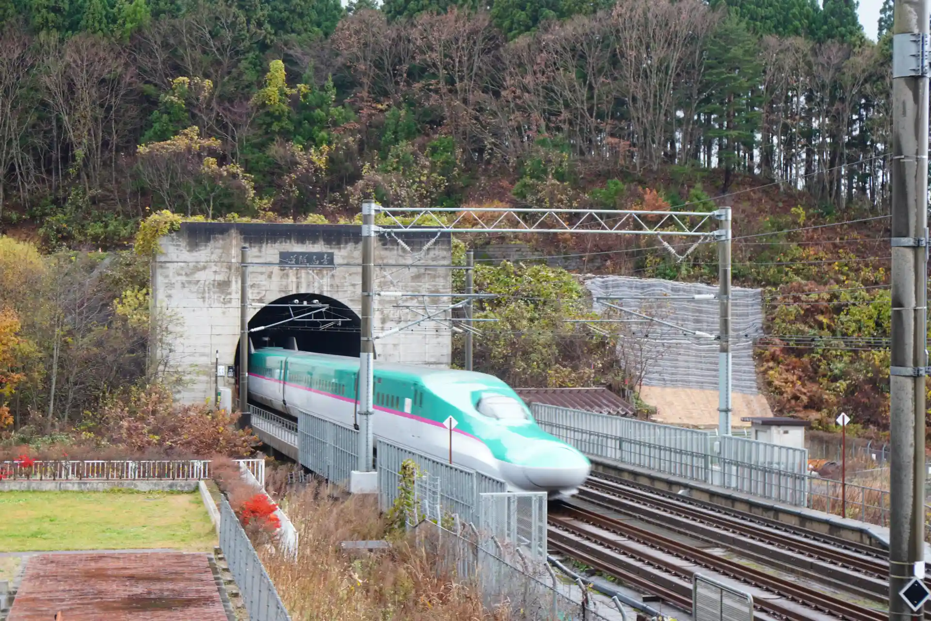 Hokkaido Shinkansen along the Seikan Tunnel route in Aomori Prefecture, where urban areas gradually give way to countryside
