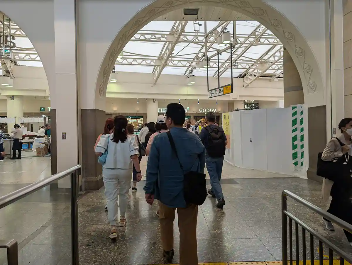 JR Ueno Station concourse after the underground escalator with shops and travelers
