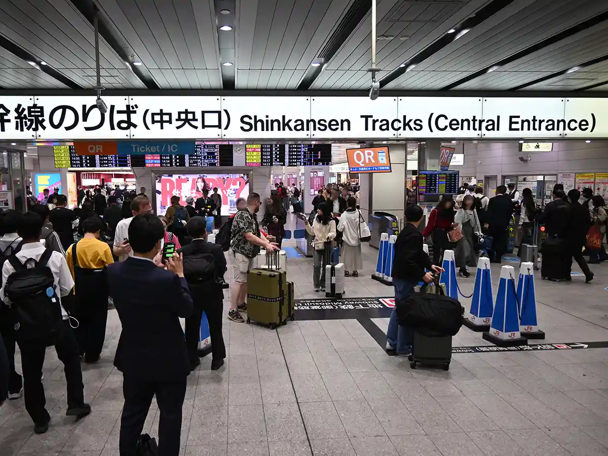 Shinkansen Central Gate area at Shin-Osaka Station with ticket gates and passengers entering platform area