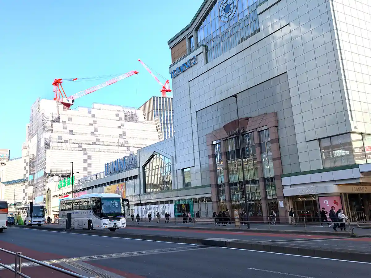 Shinjuku Station area with buses and large station buildings in central Tokyo