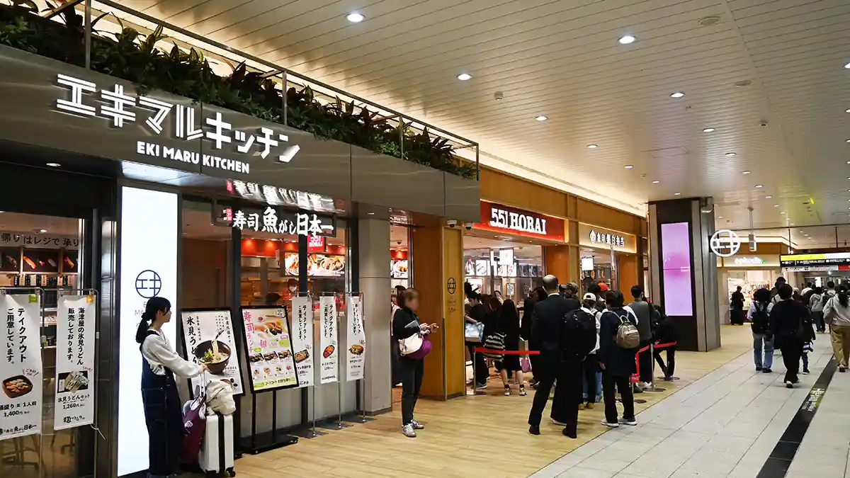 Ekimarche food area outside Shin-Osaka Station gates with sushi, bento, and 551 Horai shops