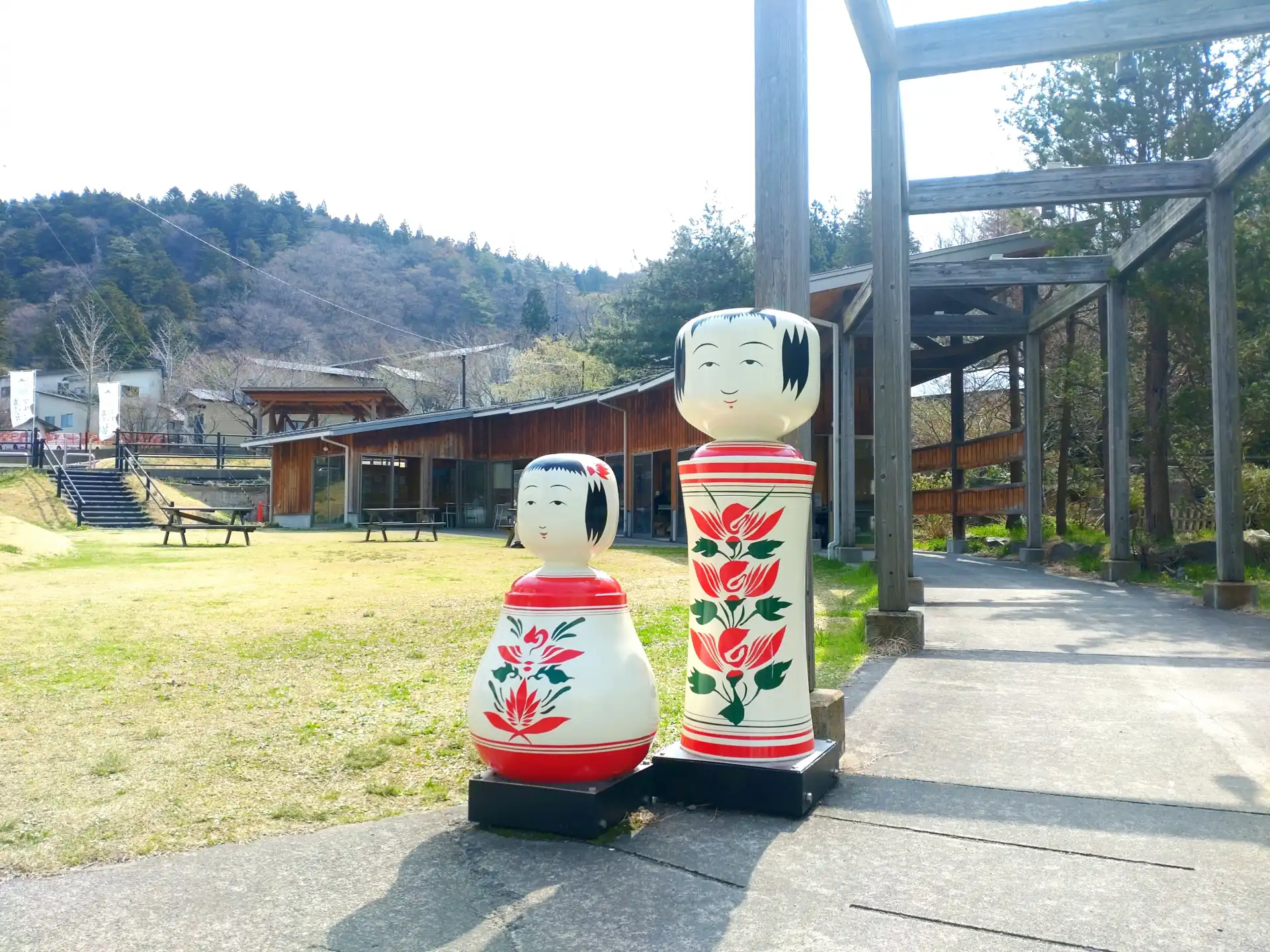 Giant kokeshi doll statues at Naruko Onsen, a famous hot spring town in Miyagi known for traditional crafts