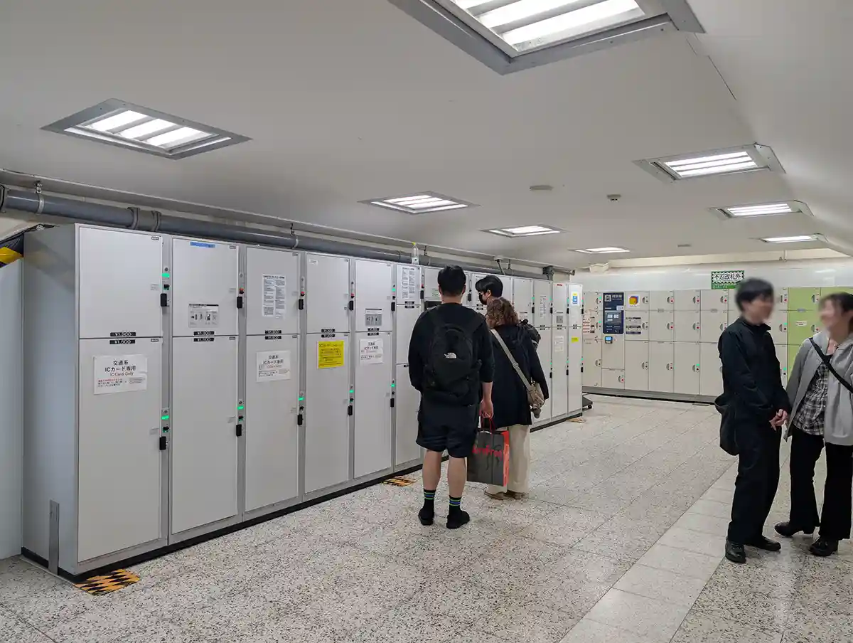  JR Ueno Station coin lockers with travelers storing luggage in the station concourse