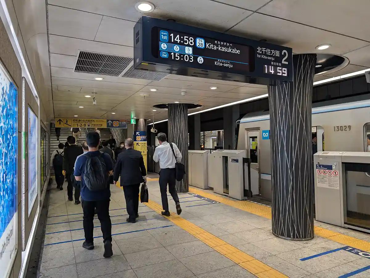 Tokyo Metro Ueno Station Hibiya Line platform with departure board and train