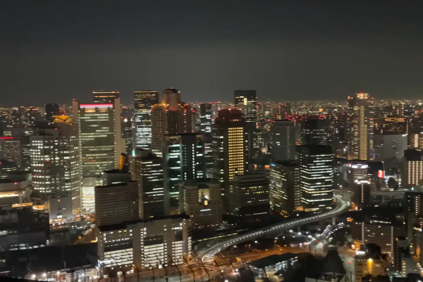 Osaka night skyline view from Umeda Sky Building observatory with illuminated skyscrapers