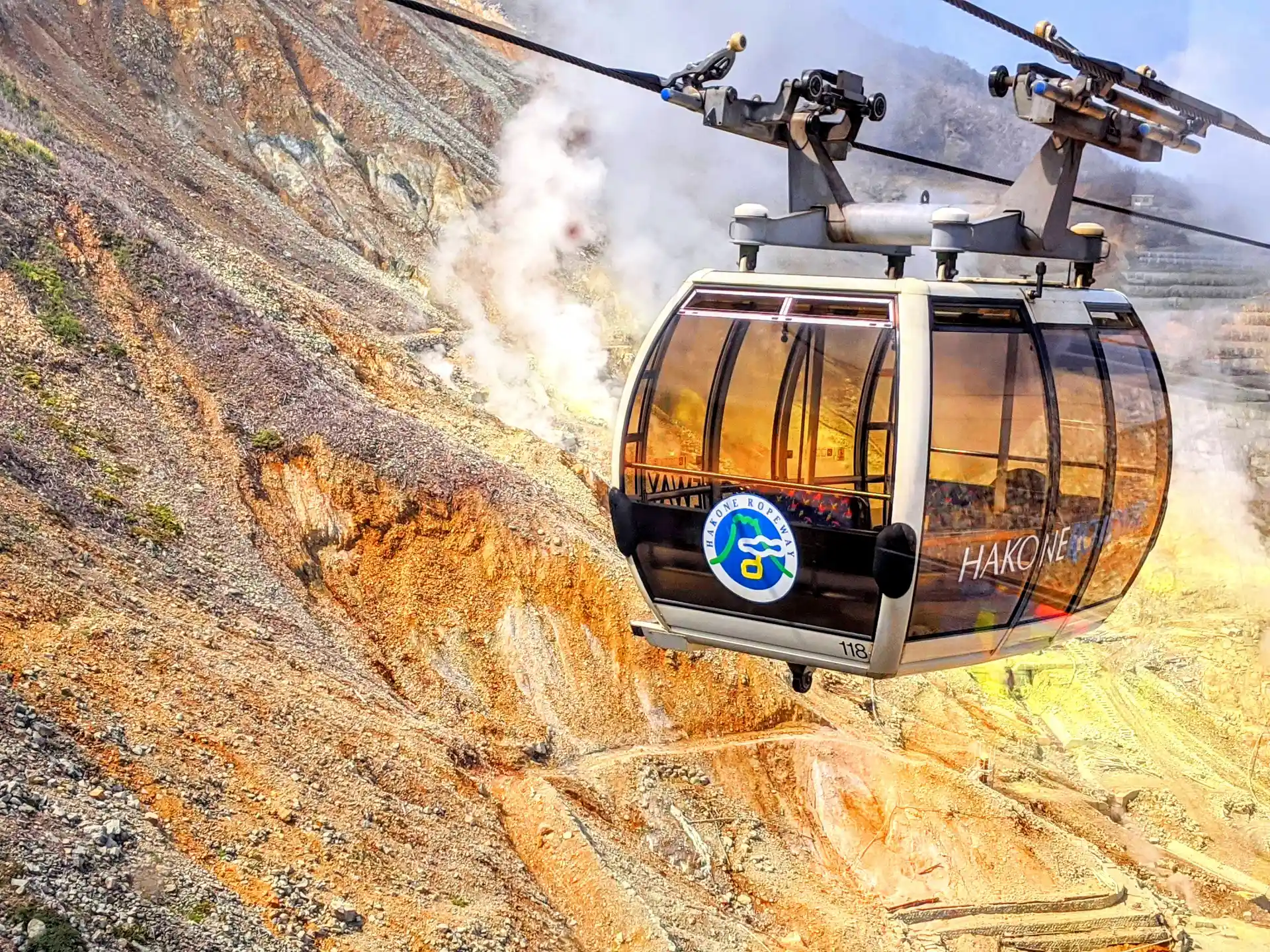 Hakone Ropeway cable car traveling over Owakudani volcanic valley