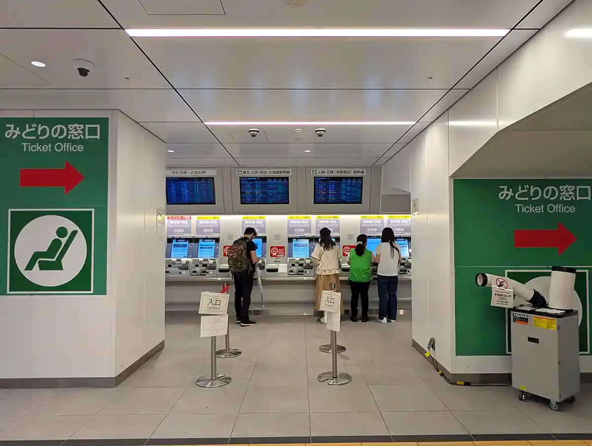 JR Ueno Station ticket machines with passengers buying Shinkansen tickets near the ticket office