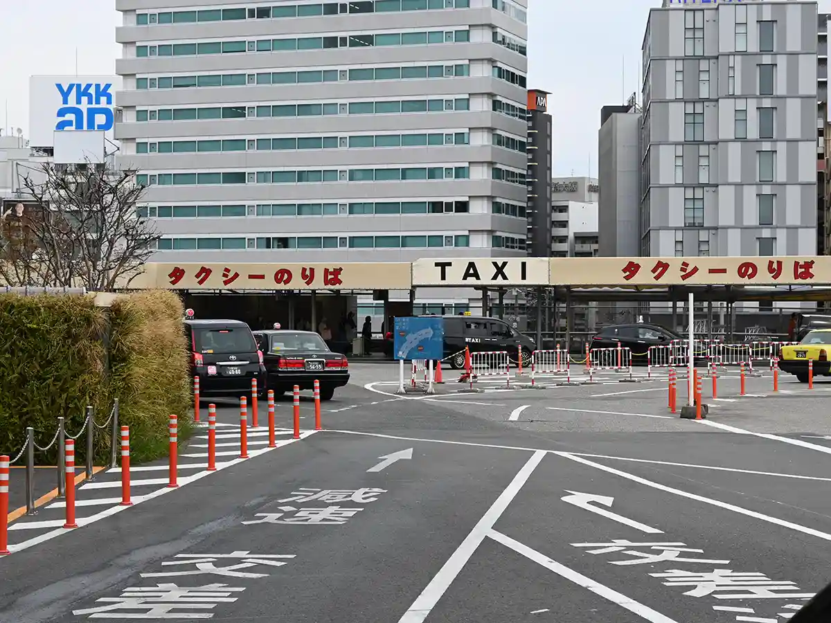 Taxi stand outside Shin-Osaka Station on 3rd floor near Shinkansen South Gate with vehicles waiting