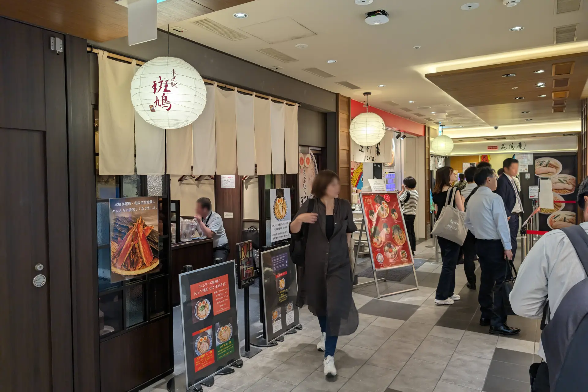 Restaurant corridor in Tokyo Station Ichibangai with customers lining up outside various Japanese eateries