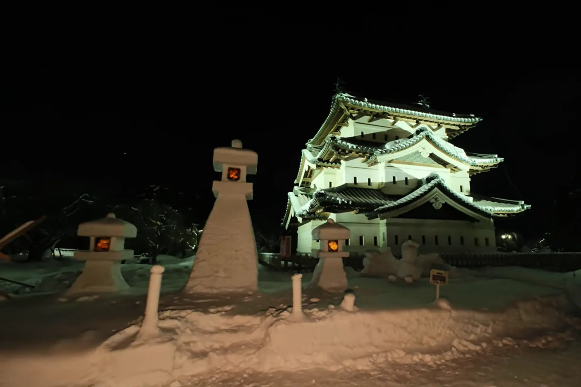 Candle-lit Tsuruga Castle surrounded by lanterns at the Aizu Painted Candle Festival in Fukushima