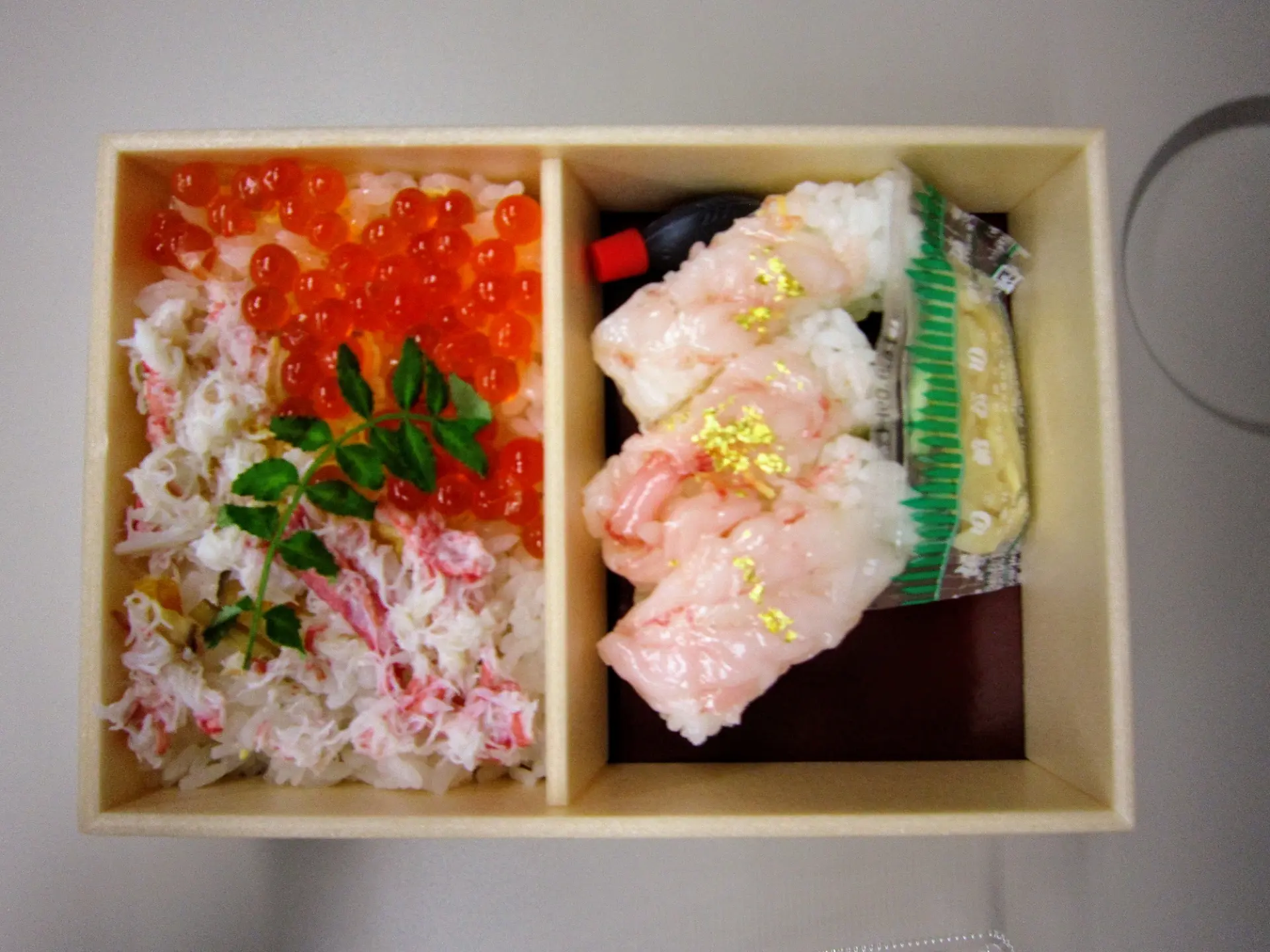 Kanazawa Station seafood ekiben (bento box) featuring crab, salmon roe, and sushi with gold leaf