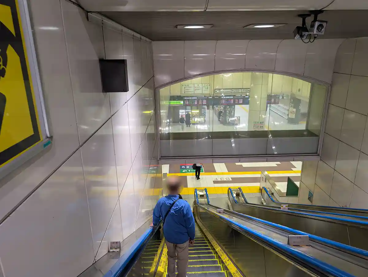 Escalator inside JR Ueno Station Shinkansen gate area leading down from 1F to B3F