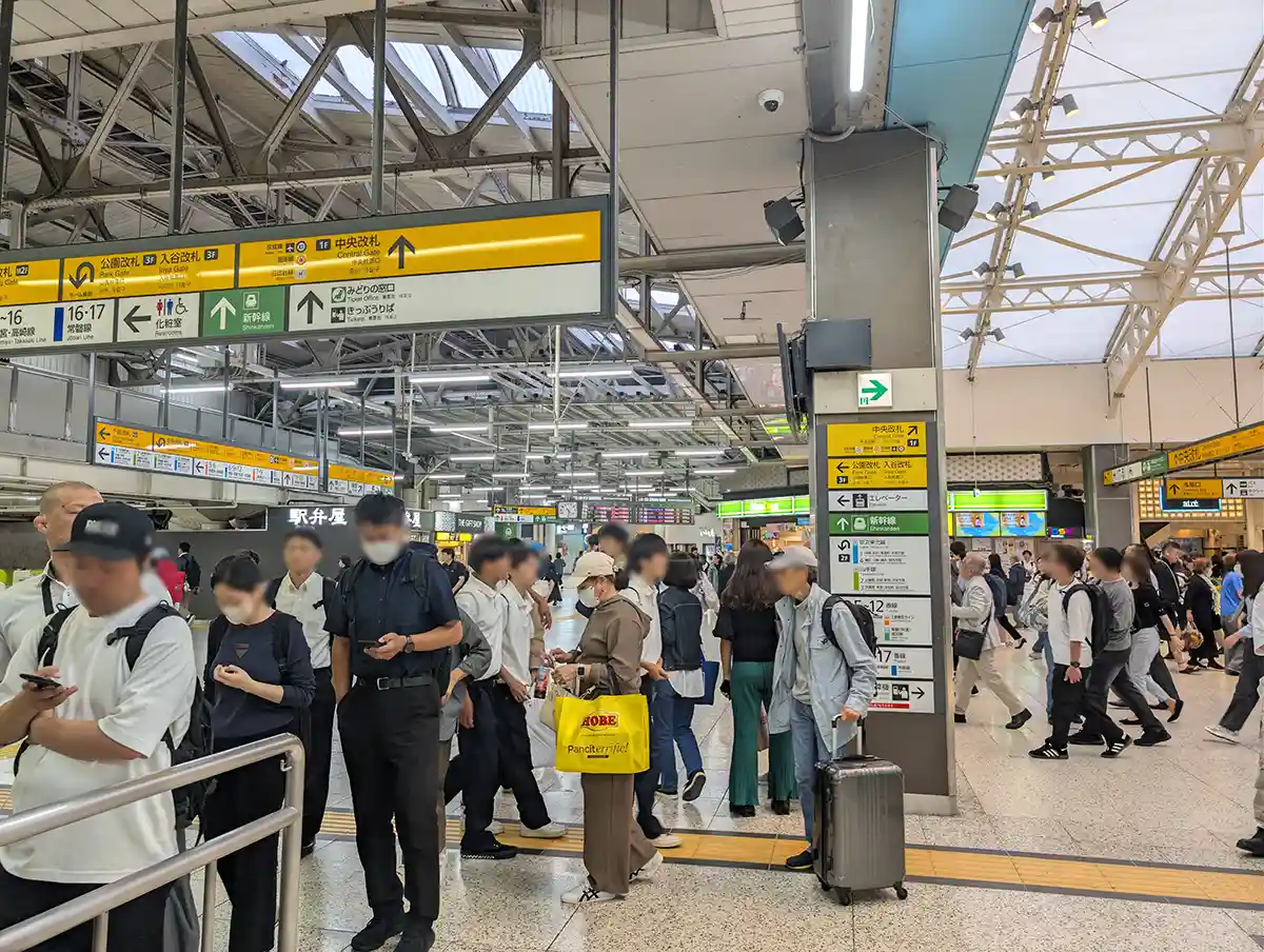 JR Ueno Station passage near the Central Gate with travelers and Shinkansen direction signs