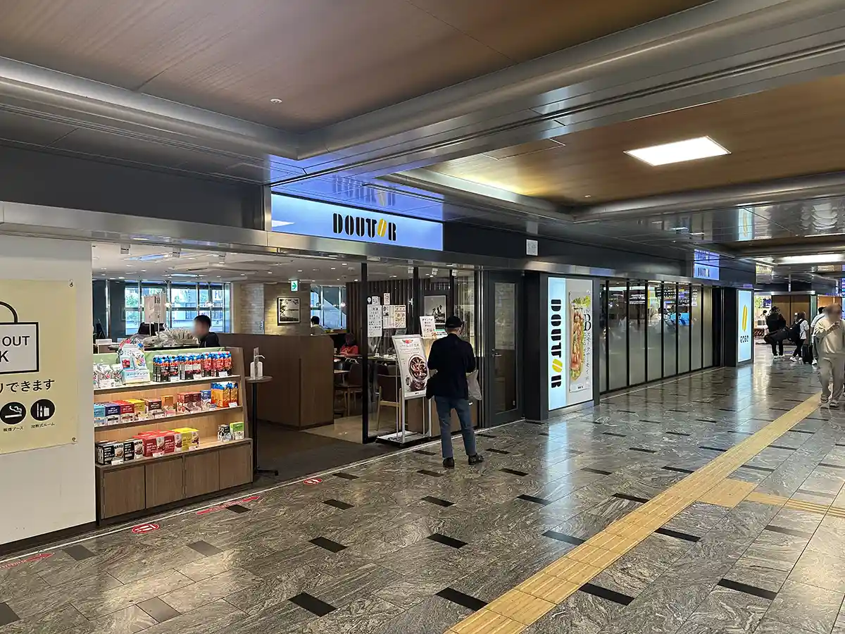 Cafe inside the Shinkansen ticket gate area at Hakata Station with seating and takeaway items