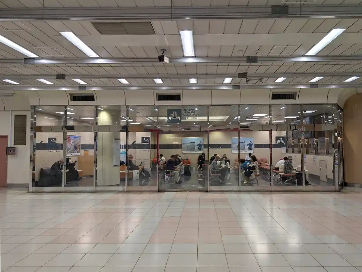 Waiting room inside JR Ueno Station Shinkansen gate area with passengers seated