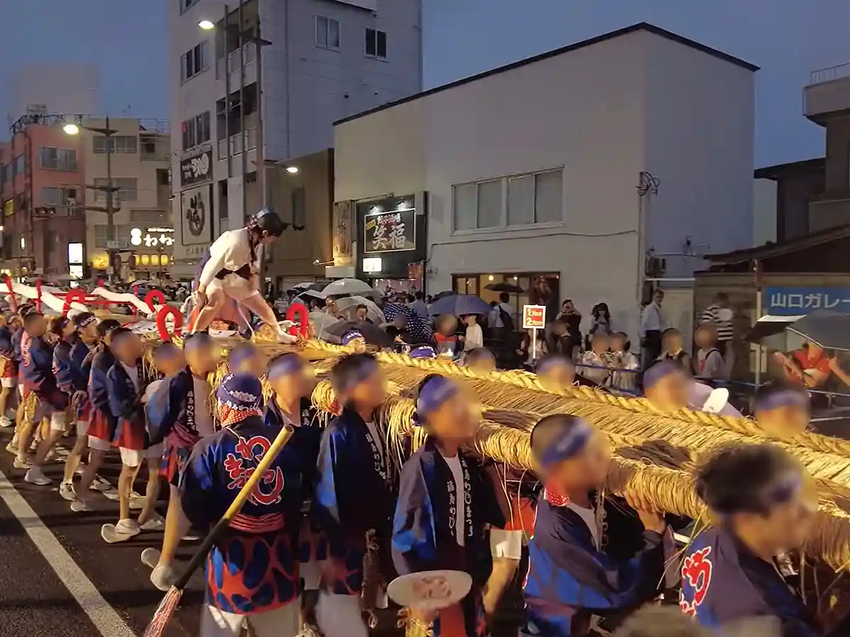 Participants parading with giant straw sandal float at Fukushima Waraji Festival in Japan