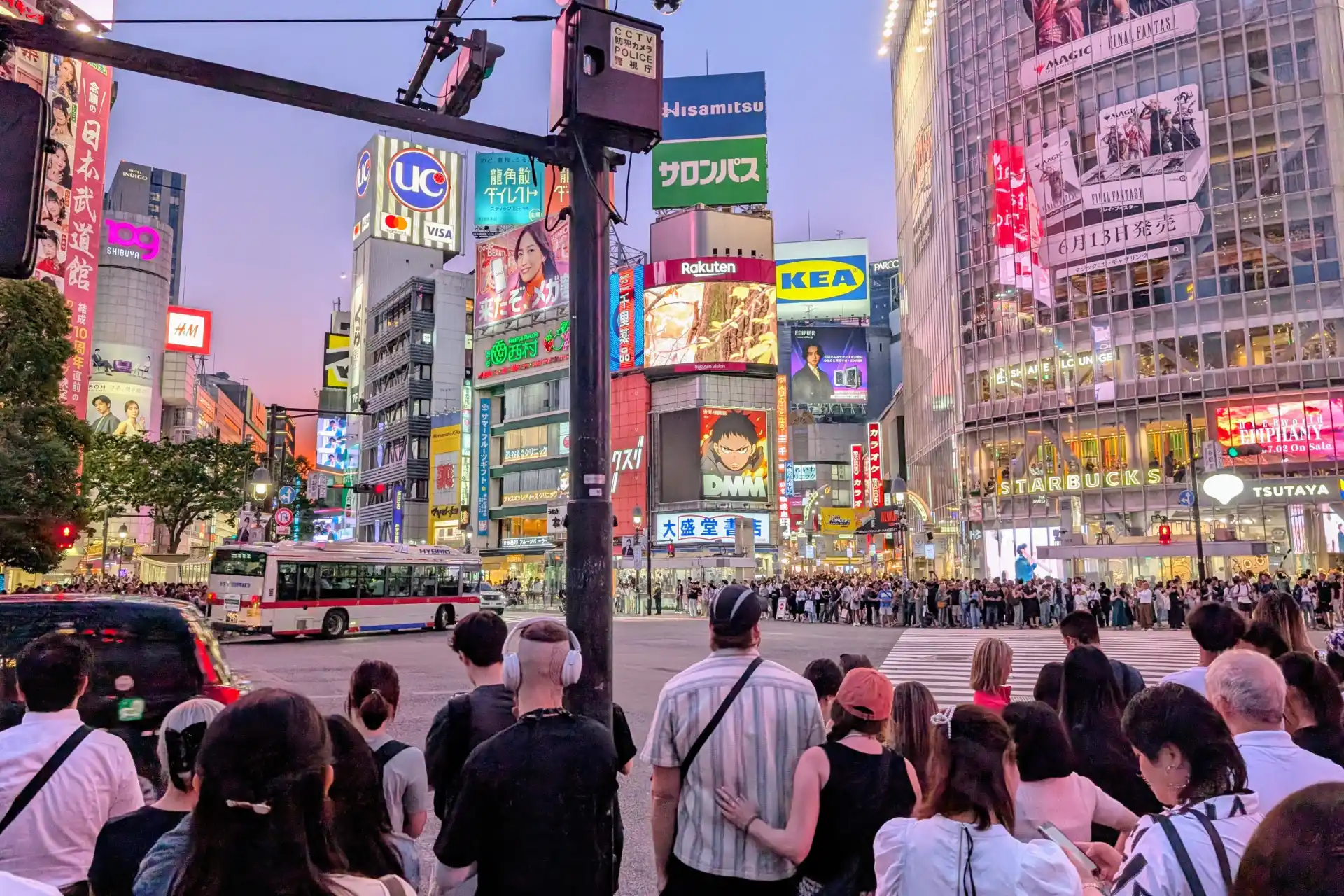 Iconic Shibuya Scramble Crossing with pedestrians and neon lights in Tokyo