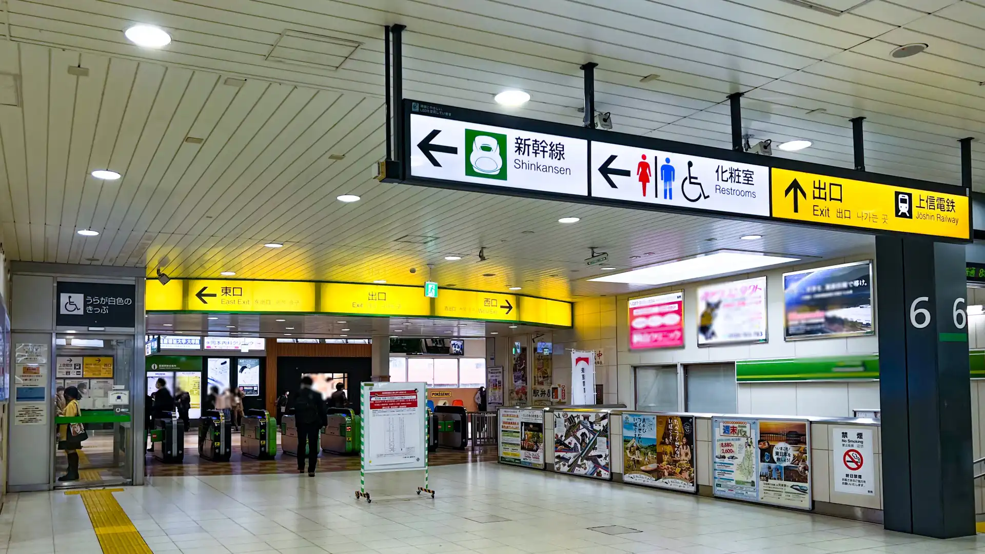 Takasaki Station main concourse with directional signage and ticket gates