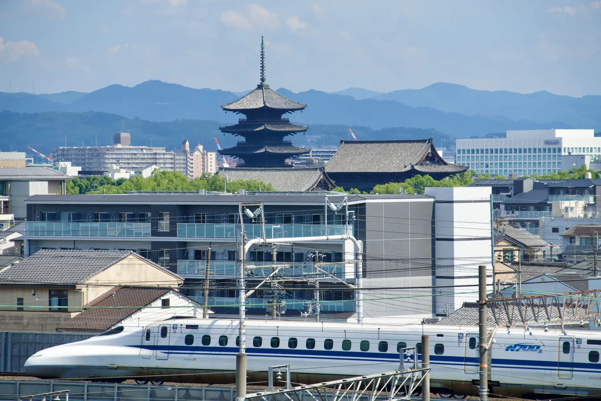 Shinkansen with Toji Temple and Kyoto cityscape in the background
