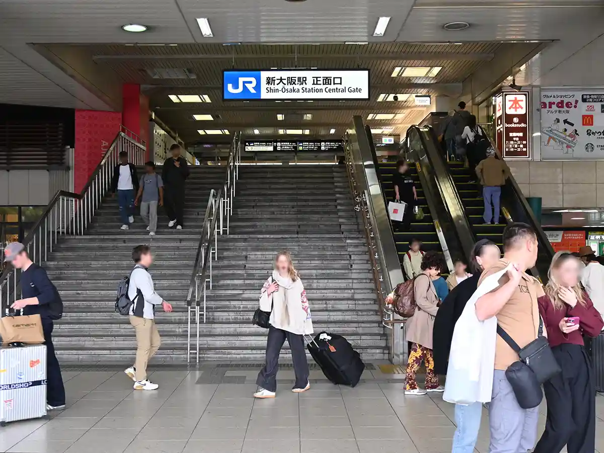 JR Shin-Osaka Station front entrance with stairs and escalators leading to platforms