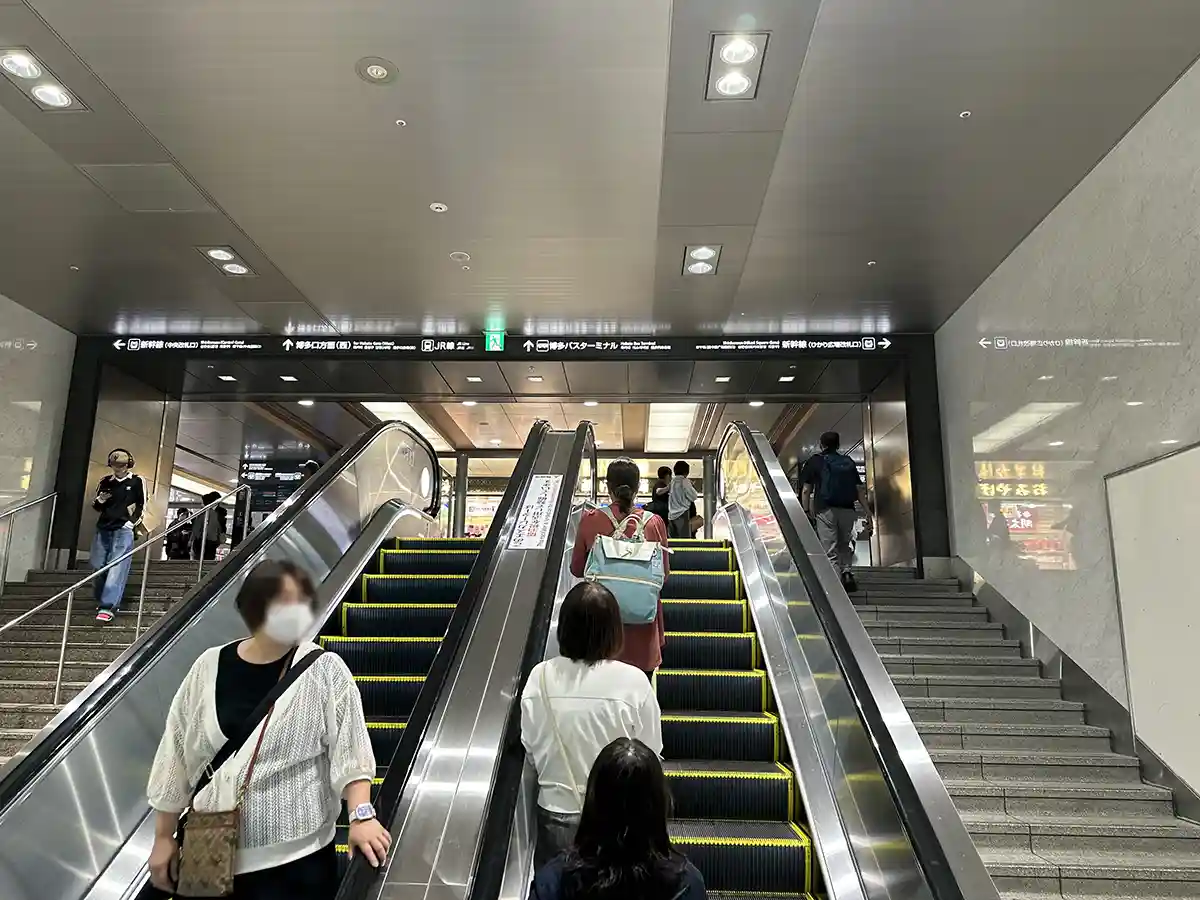 Escalators leading from the Fukuoka City Subway toward the Shinkansen area at Hakata Station