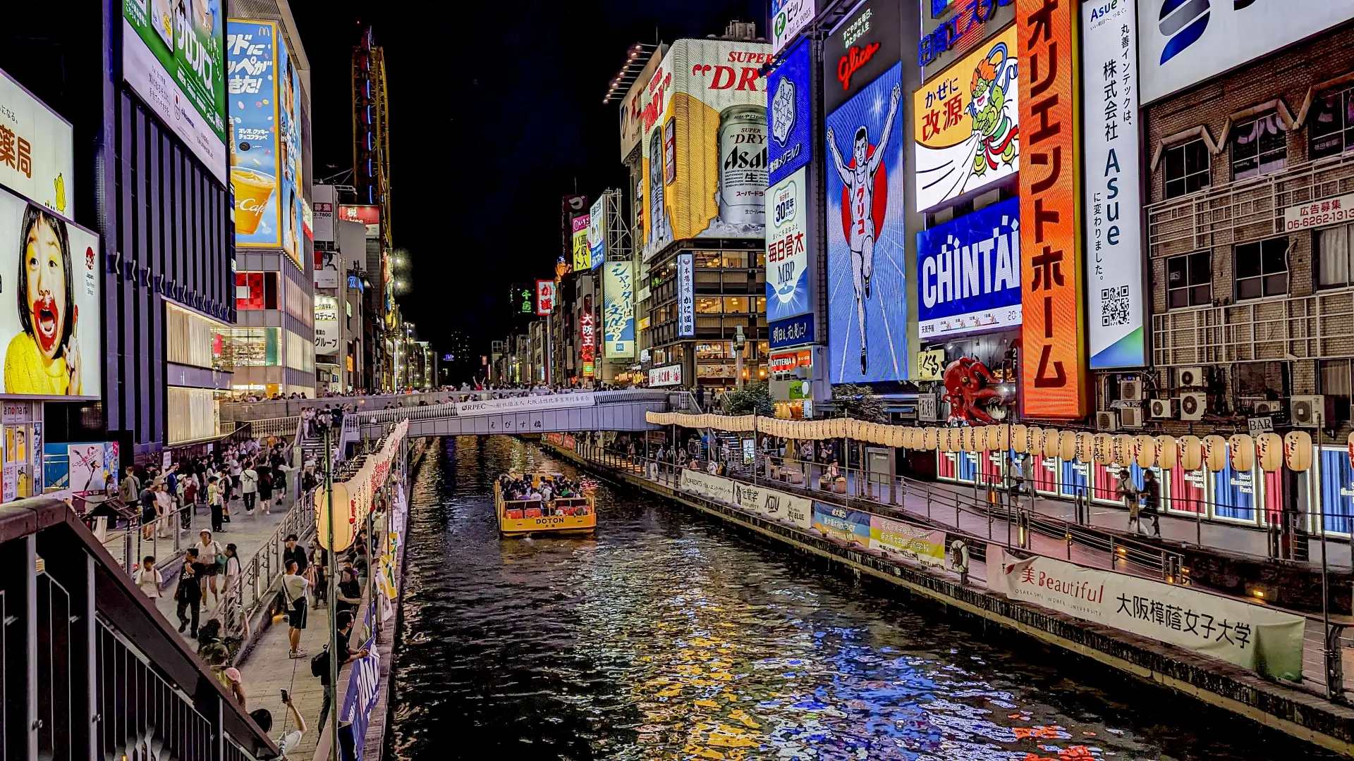 Dotonbori Riverwalk at night with the iconic Glico sign and neon lights in Osaka