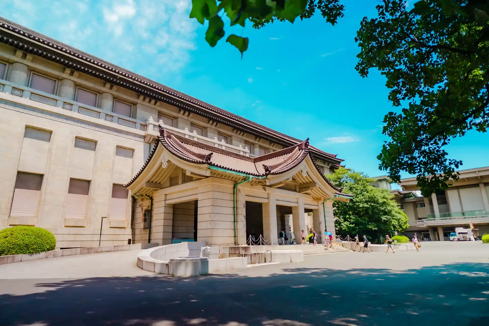Tokyo National Museum building with traditional entrance and trees in Ueno Park