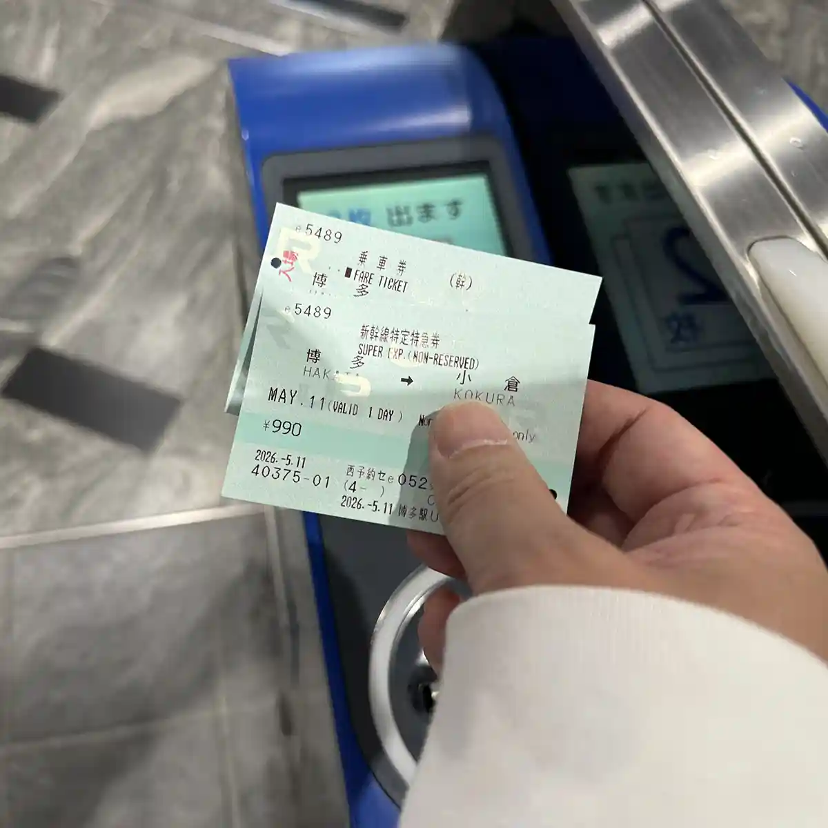 Passenger collecting returned Shinkansen tickets from the automatic gate at Hakata Station