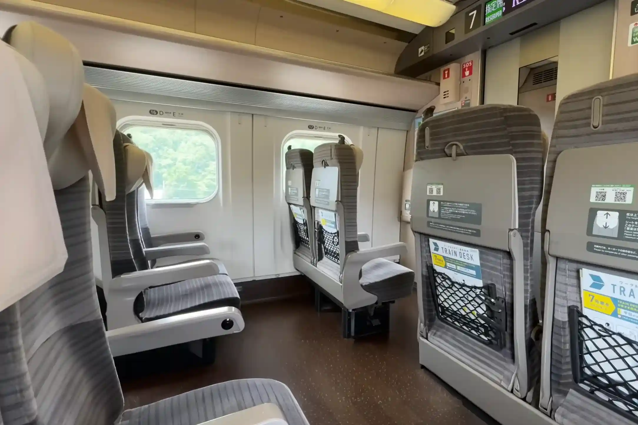 Ordinary seat layout inside the Hokkaido Shinkansen, showing seat spacing, seat backs, and windows for passenger comfort
