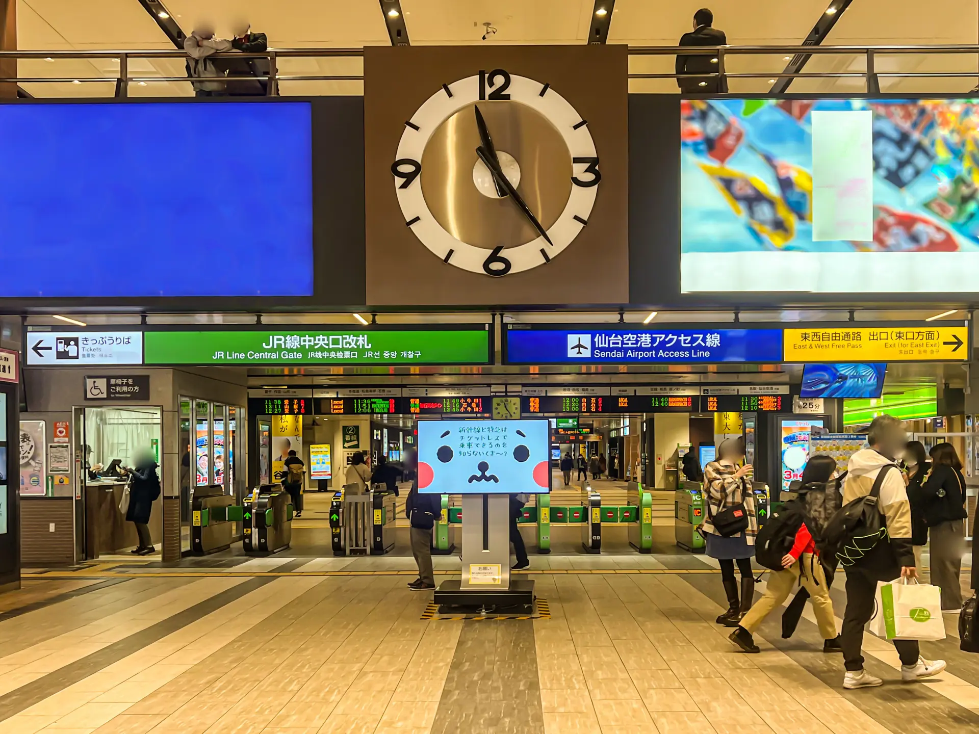 JR Line Central Gate and Sendai Airport Access Line entrance inside Sendai Station with travelers walking under a large clock