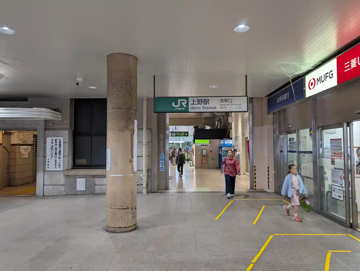 JR Ueno Station entrance area with Asakusa Exit sign and nearby bank storefront